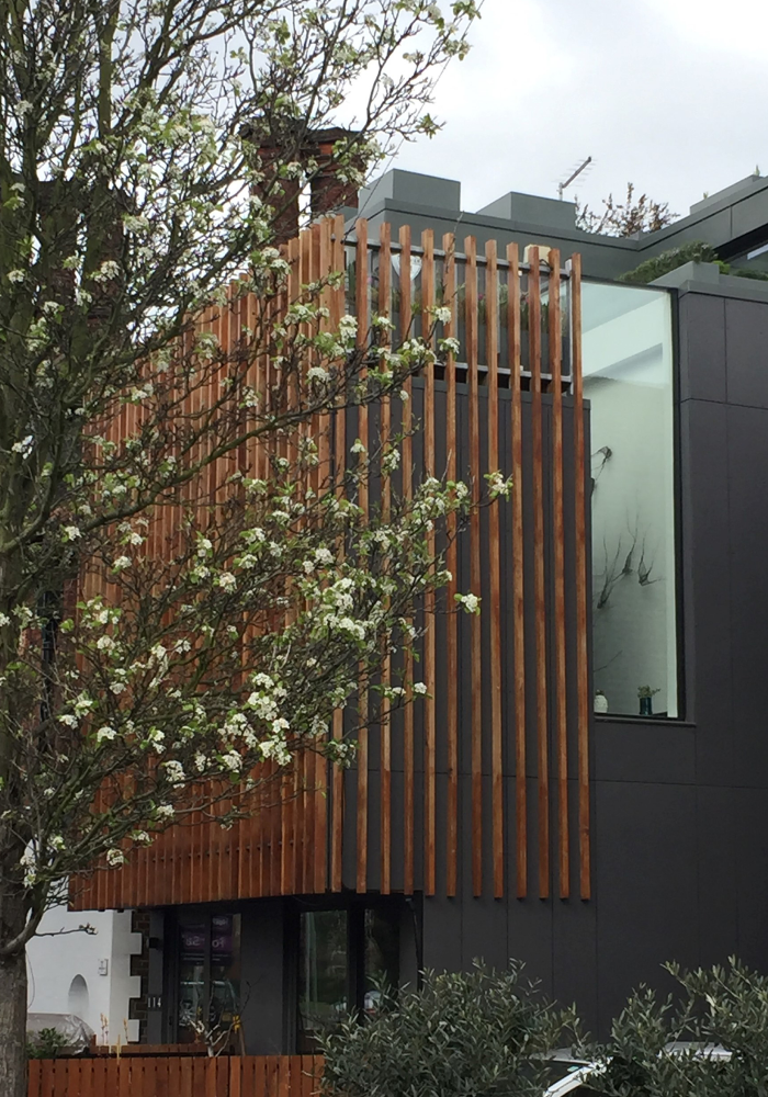 Shows a close up of the wooden panneling design on the exterior