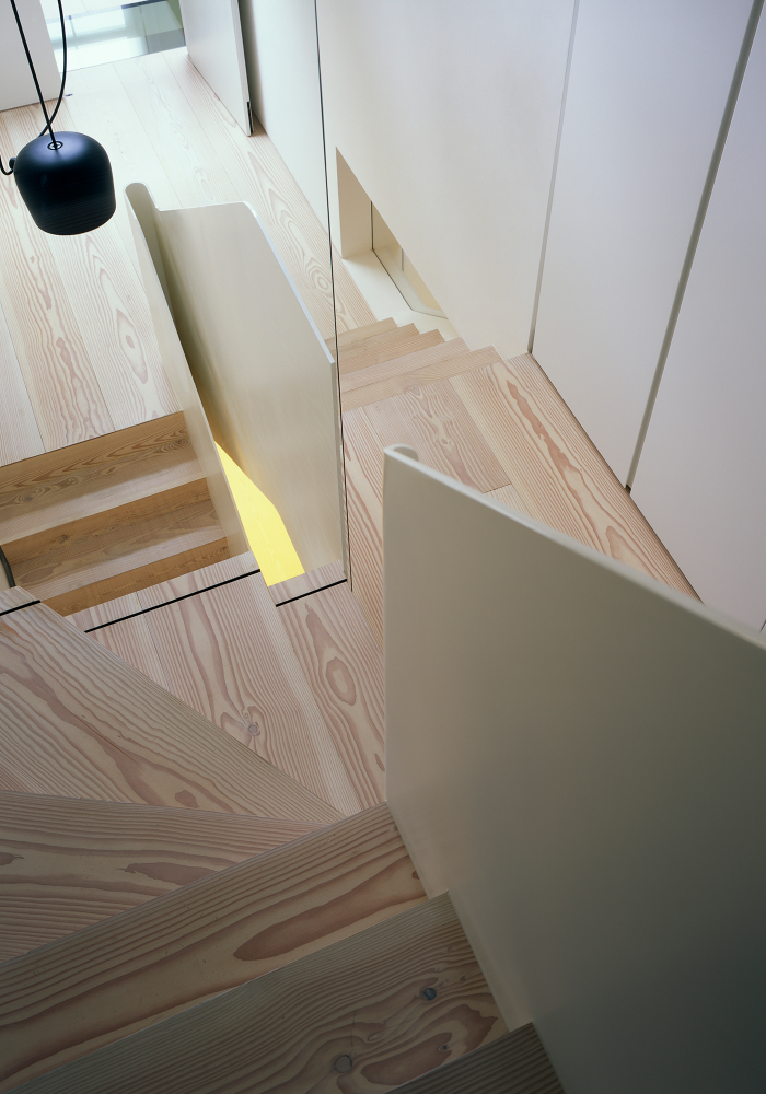 Shows a top interior view of the wooden staircase from the Sartor House architectural project