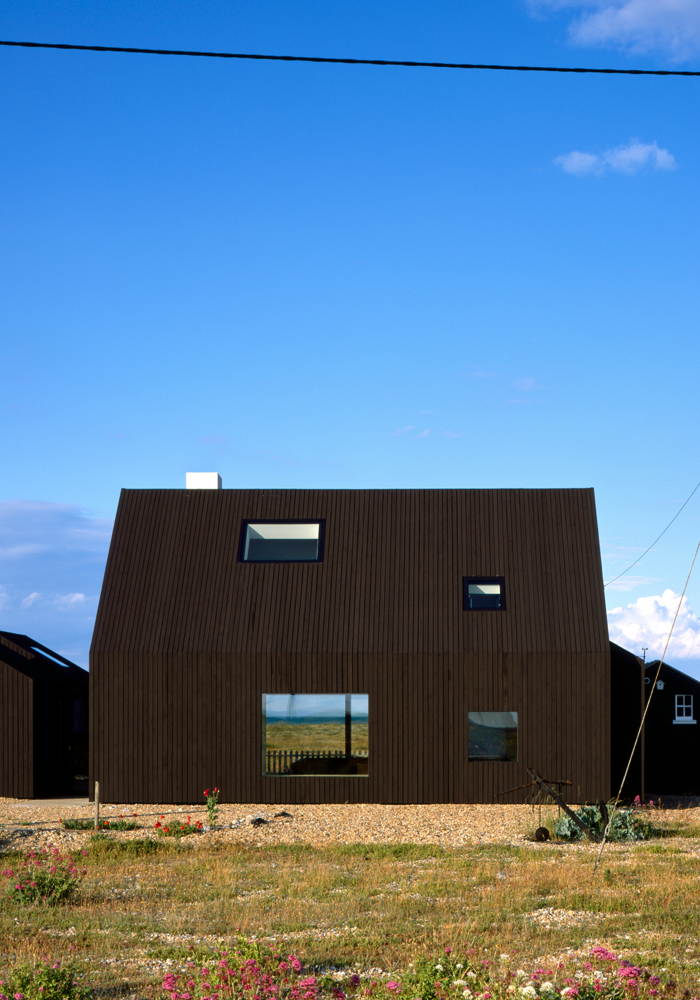 Shows an exterior view of the renovated barn in the daylight - North Vat Architectural Project, Dungeness