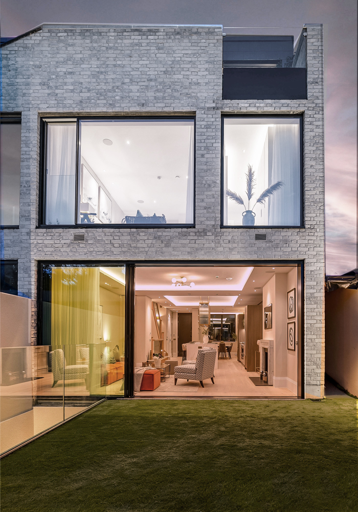 Shows a close up of the renovated house in Wandsworth from the back at night